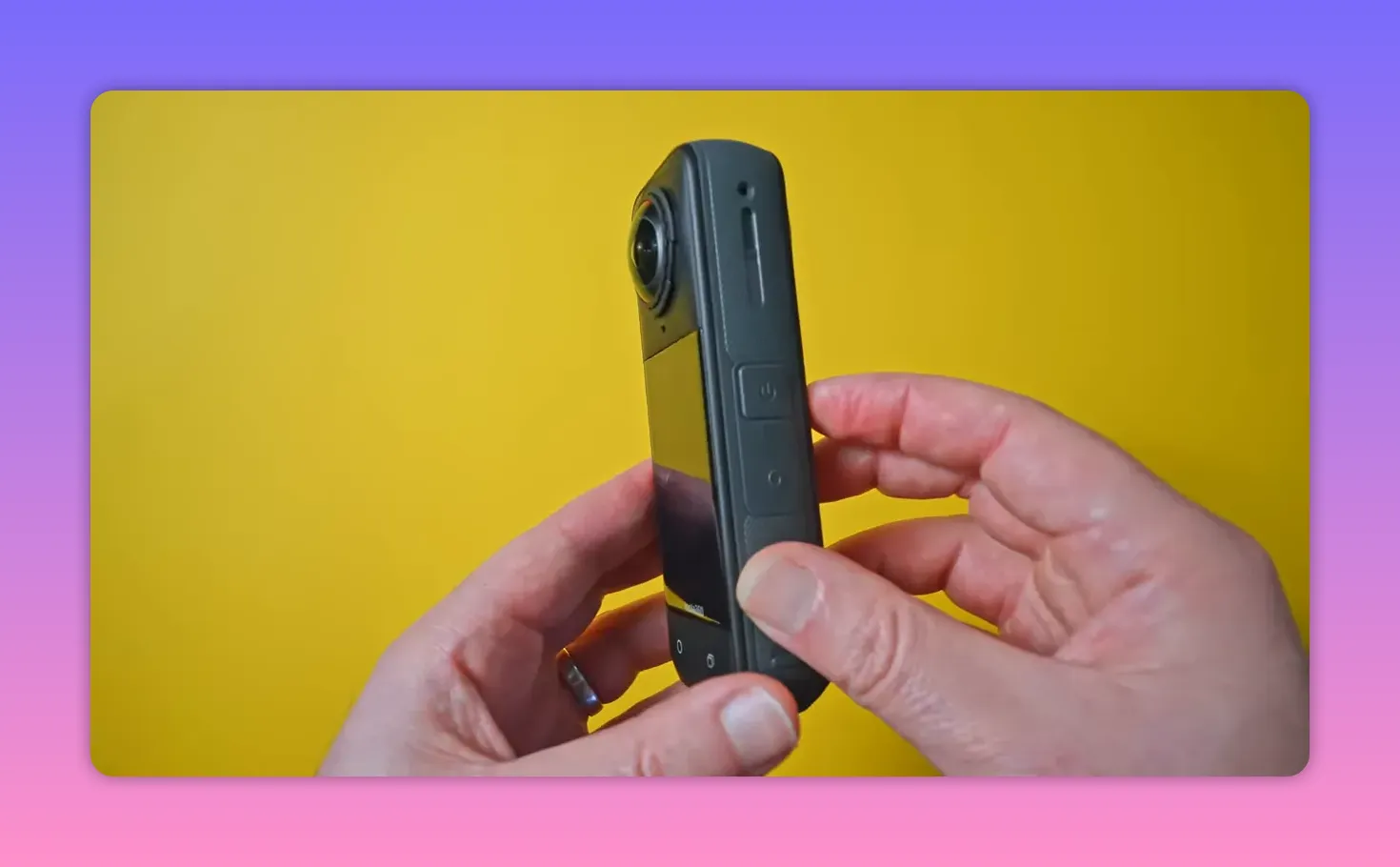 Side view of the Insta360 X5 showing the power button, side controls and part of the screen while being held