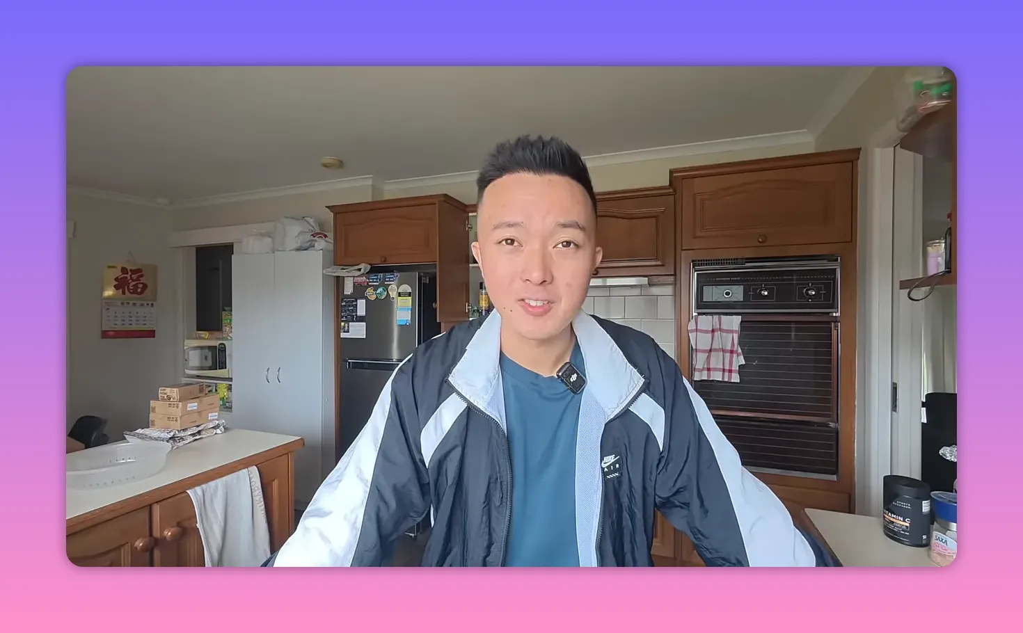 Person standing in a home kitchen discussing cost of living with appliances and cabinets visible