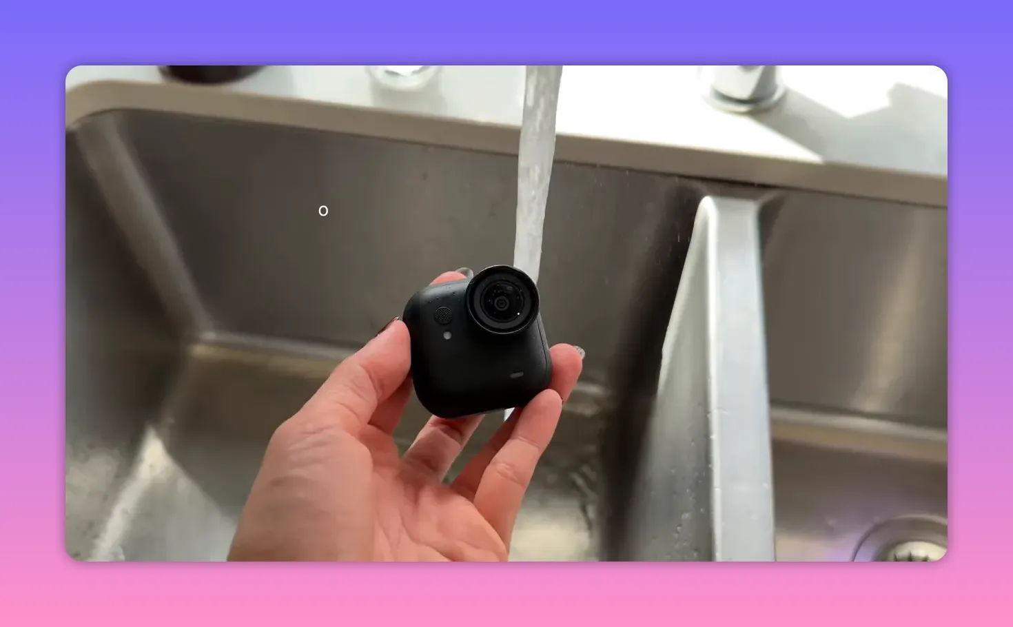 Insta360 X5 Ultra held under a running faucet to show waterproofing