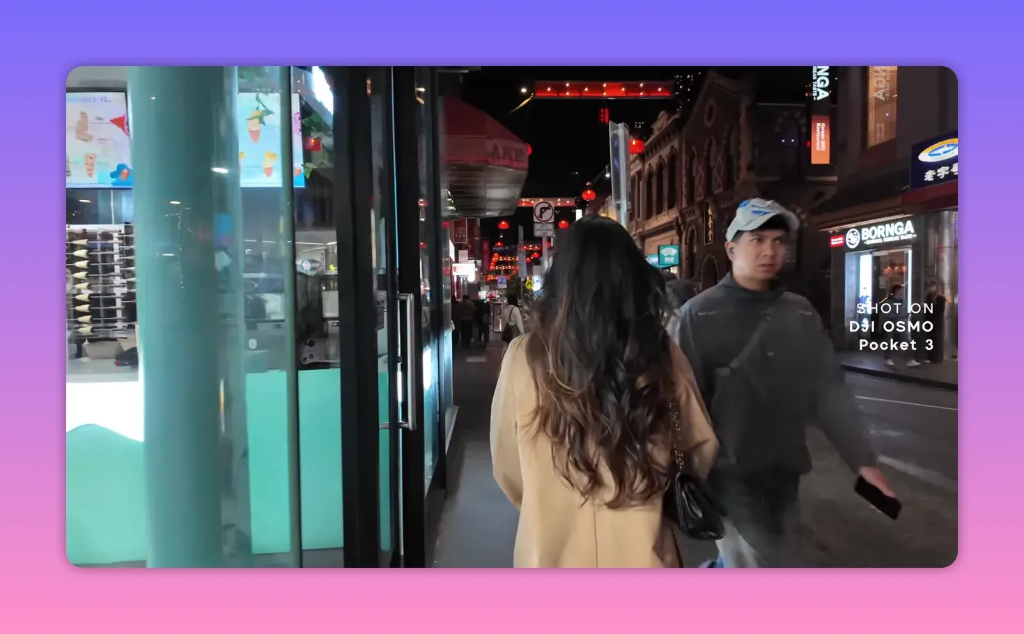 Night street POV of a creator walking with city lights and 'Shot on DJI Osmo Pocket 3' watermark