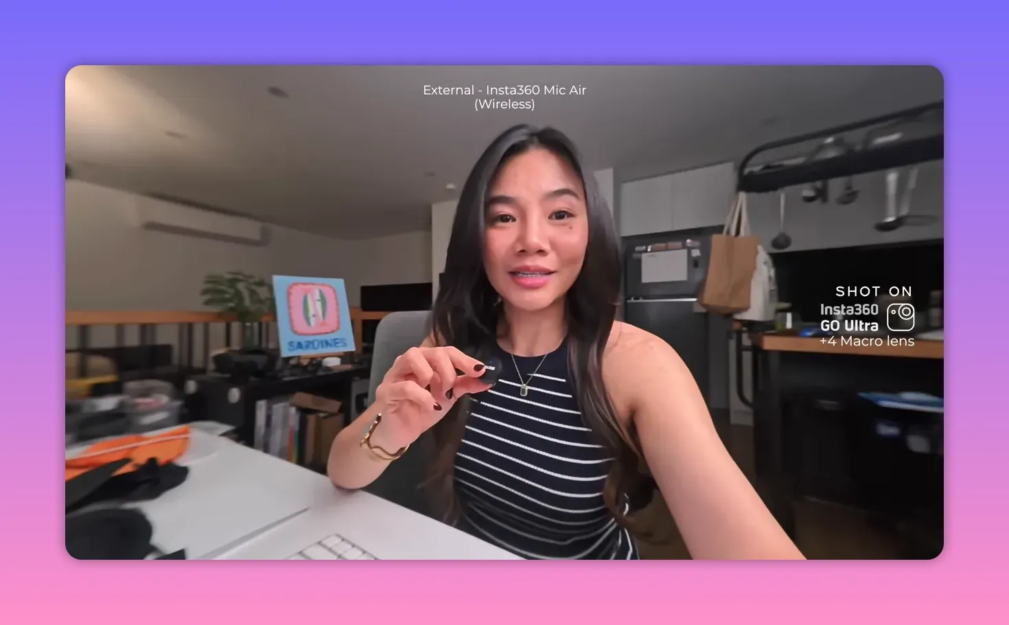 Presenter holding the Insta360 Mic Air wireless lav close to her collar to demonstrate audio quality