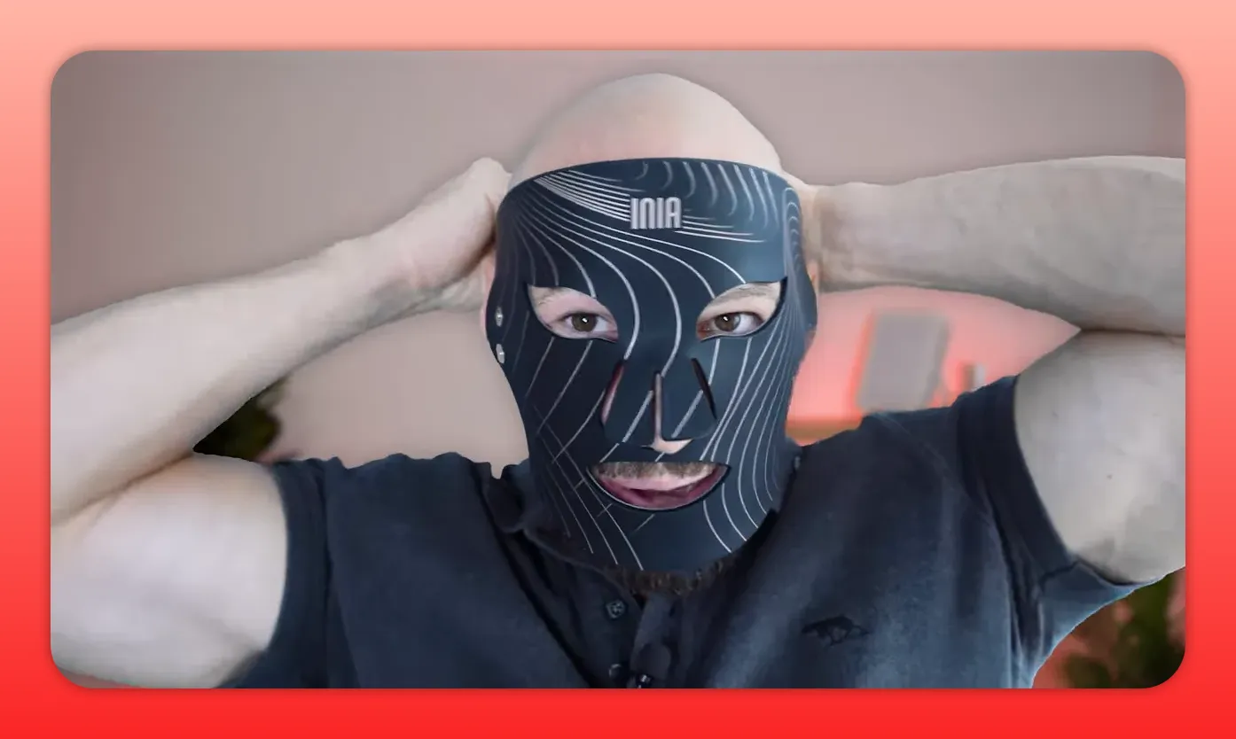 Reviewer wearing Inia Glow mask with strap pulled back showing nose cutout and strap placement