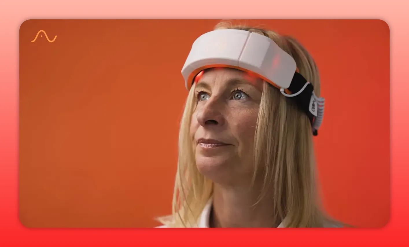 Close up of a red light therapy headband worn on the forehead with LEDs visible