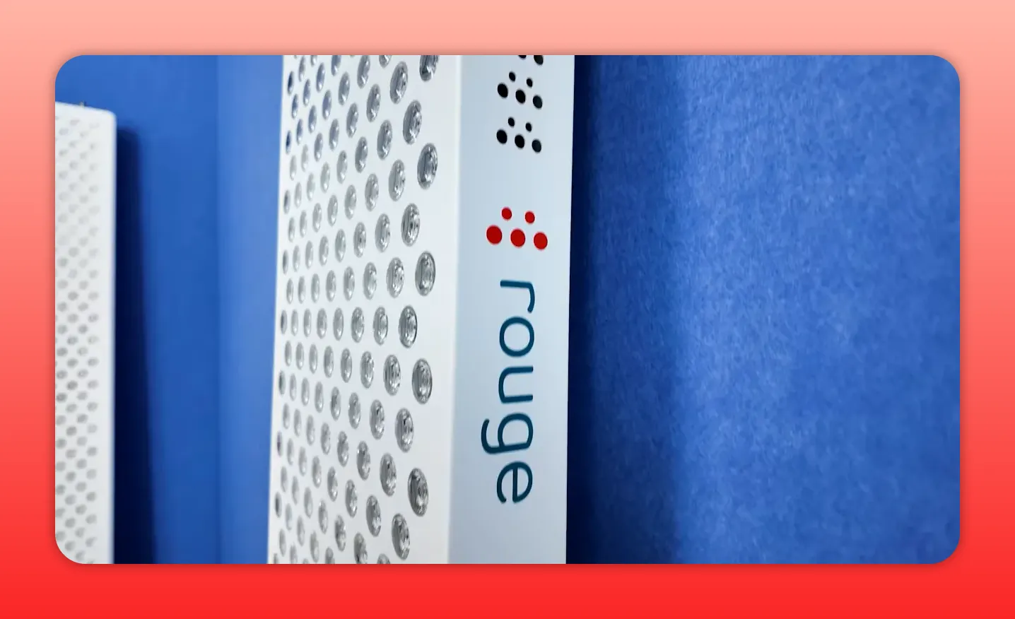 Close-up vertical view of a Rouge red light therapy panel showing diode lenses and 'rouge' logo