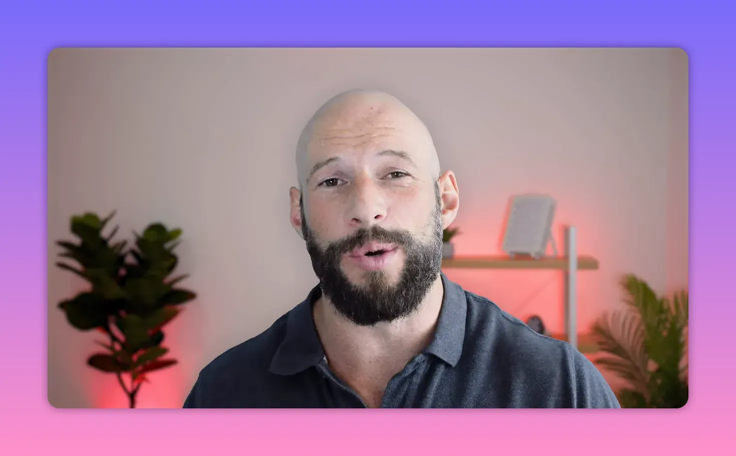 Presenter speaking with a red LED therapy panel and shelf visible in the background.