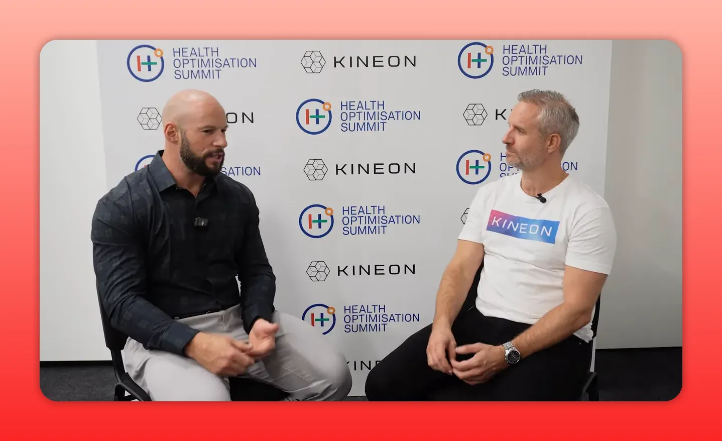 Two presenters seated in front of Kineon/Health Optimisation Summit branding in a clear, well-lit interview frame.