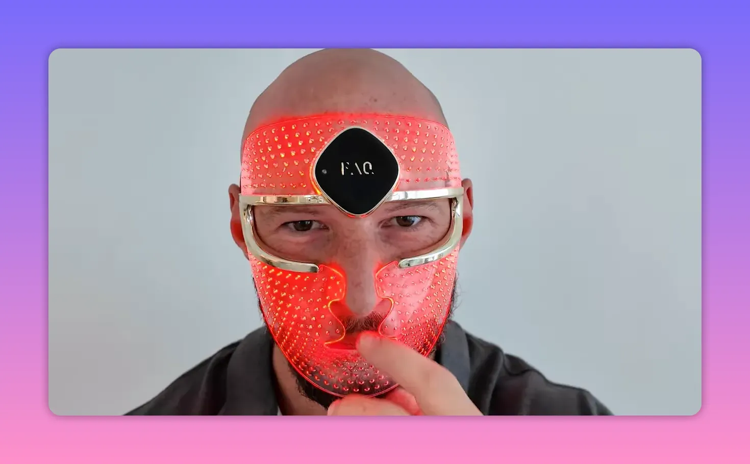 Illuminated LED face mask with red LEDs, front view showing dense diode layout and facial coverage.