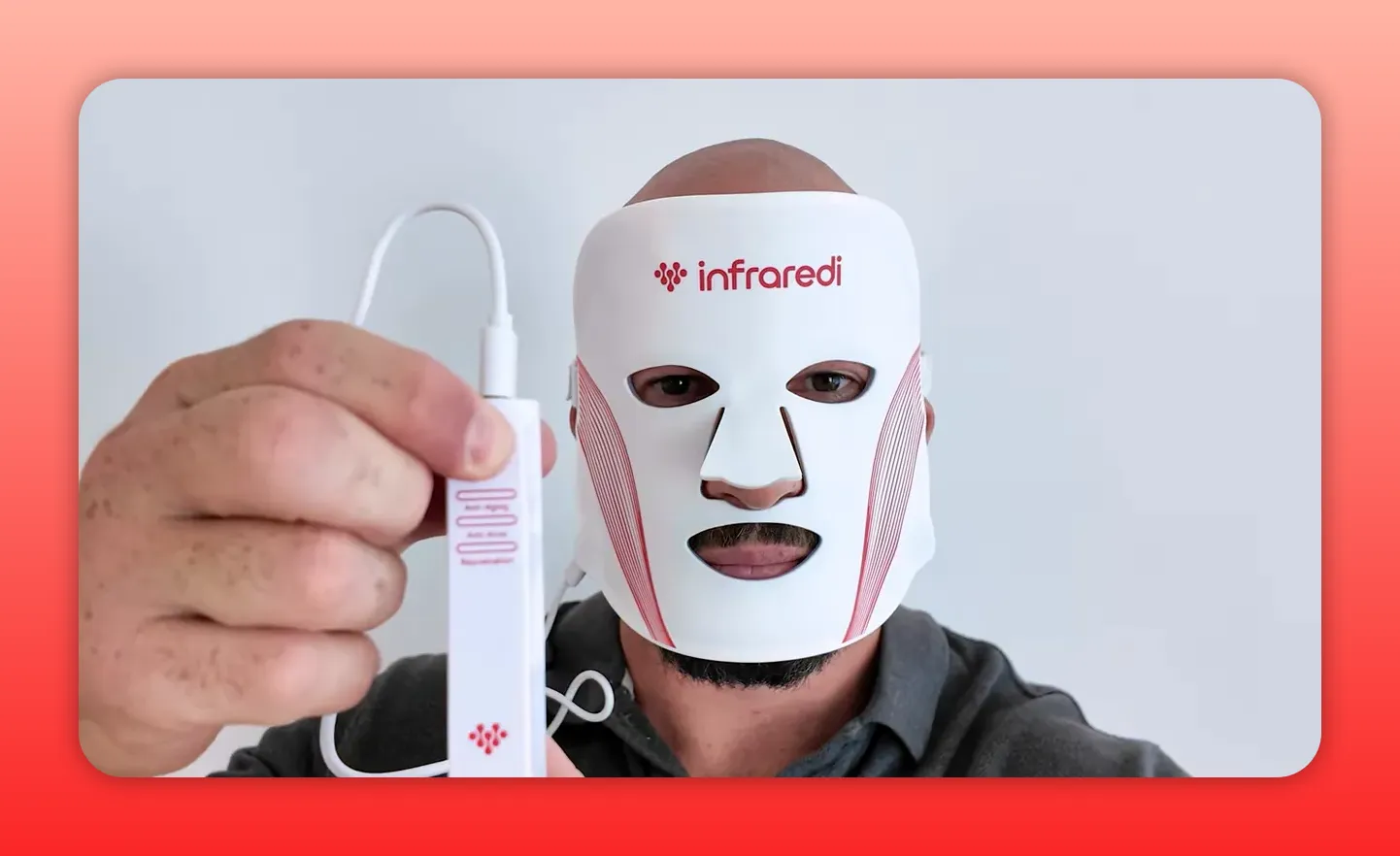 infraredi white LED face mask held up with controller in foreground