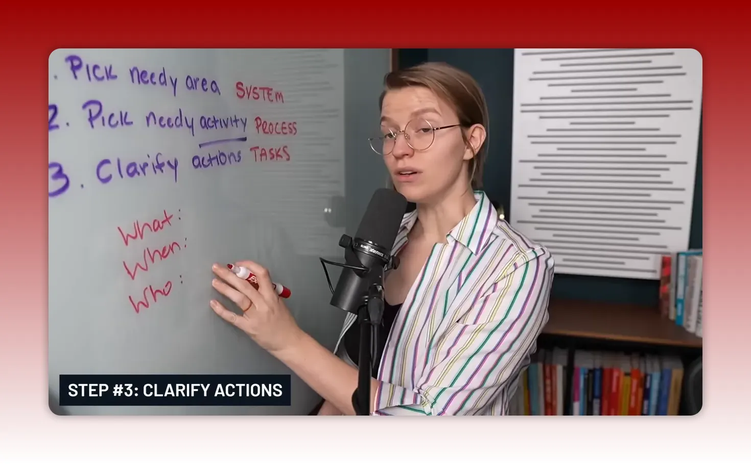 Presenter writing 'What: When: Who:' on a whiteboard while explaining Step 3 Clarify Actions