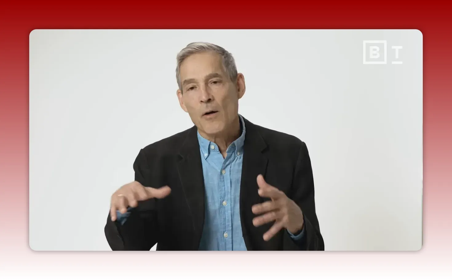 Speaker in a blazer using open hand gestures as if assembling pieces while explaining memory reconsolidation.