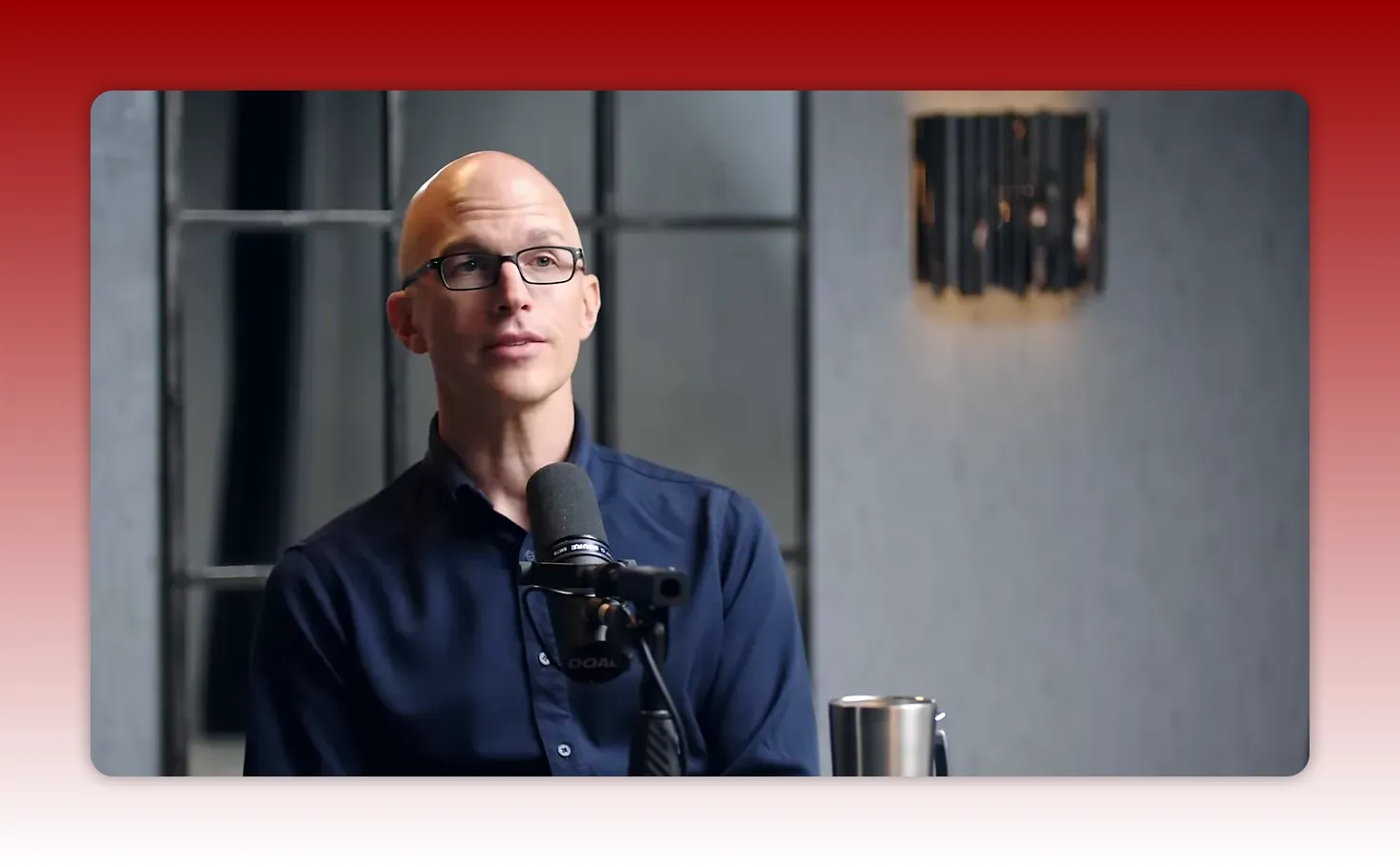 podcast guest speaking into microphone in studio, looking thoughtful while discussing finance