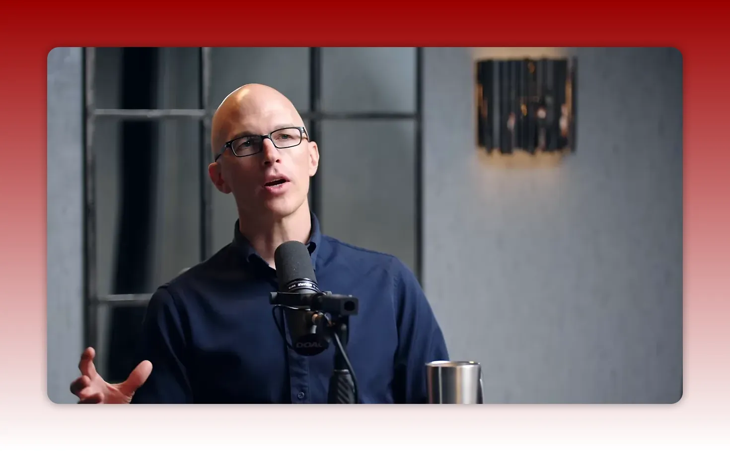 podcast host gesturing while making a point into a microphone