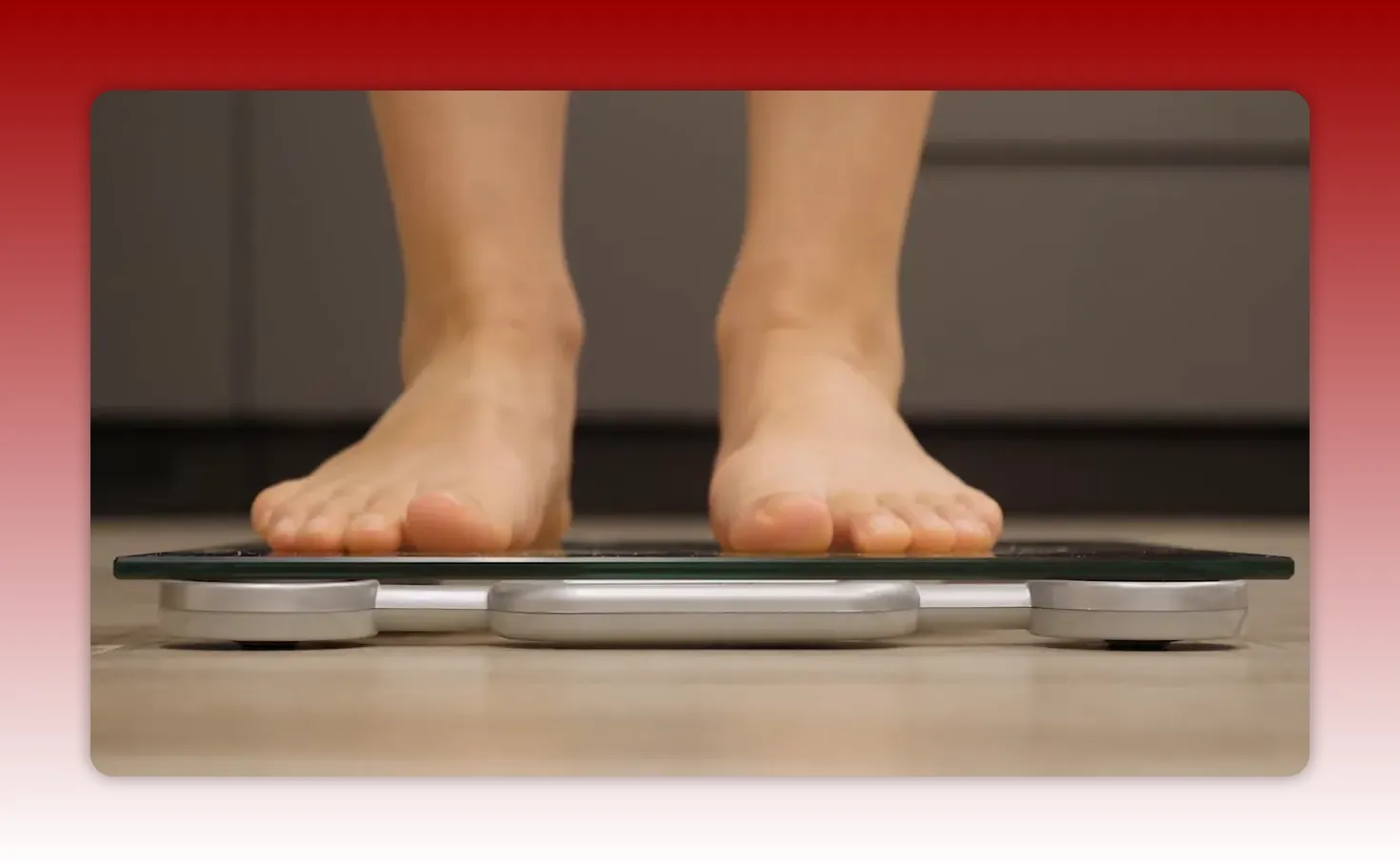 Two feet standing on a digital bathroom scale viewed from a low angle