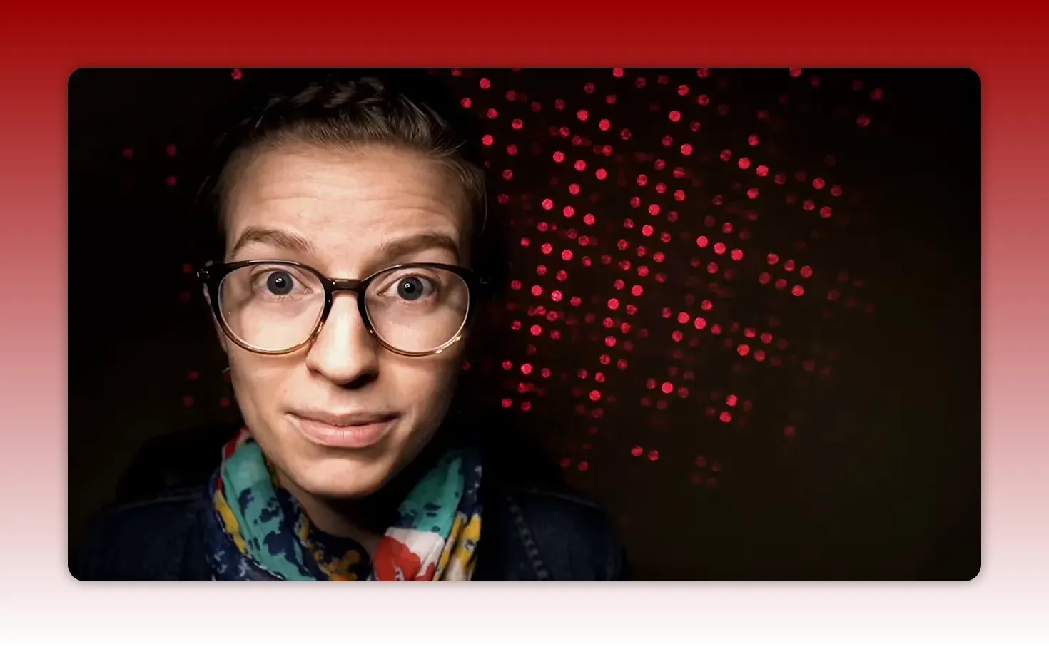Presenter looking directly at camera with red dotted background illustrating documentation advice