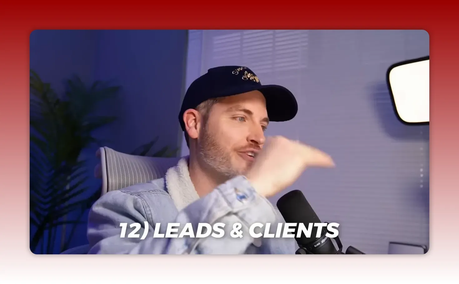 Creator pointing while on-screen text reads '12) LEADS & CLIENTS' — speaking into a microphone in a home studio.