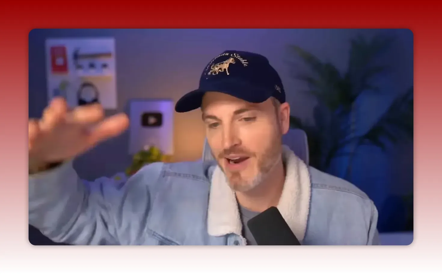 Creator gesturing while explaining a YouTube-to-leads funnel, microphone visible in the foreground and studio backdrop behind.