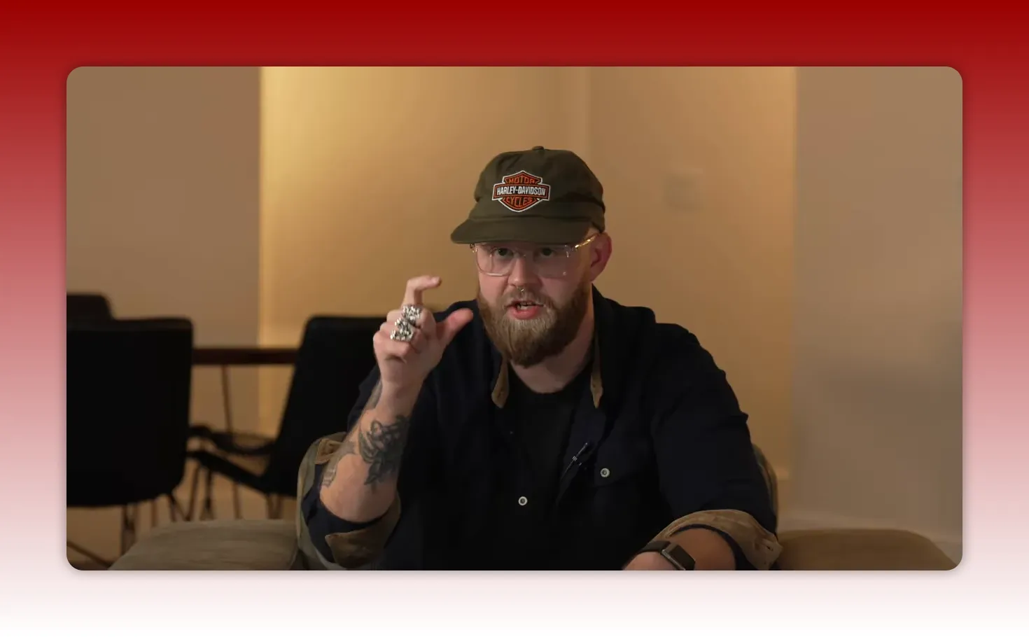 Presenter pinching fingers to indicate a small but important detail while discussing packaging and thumbnails.