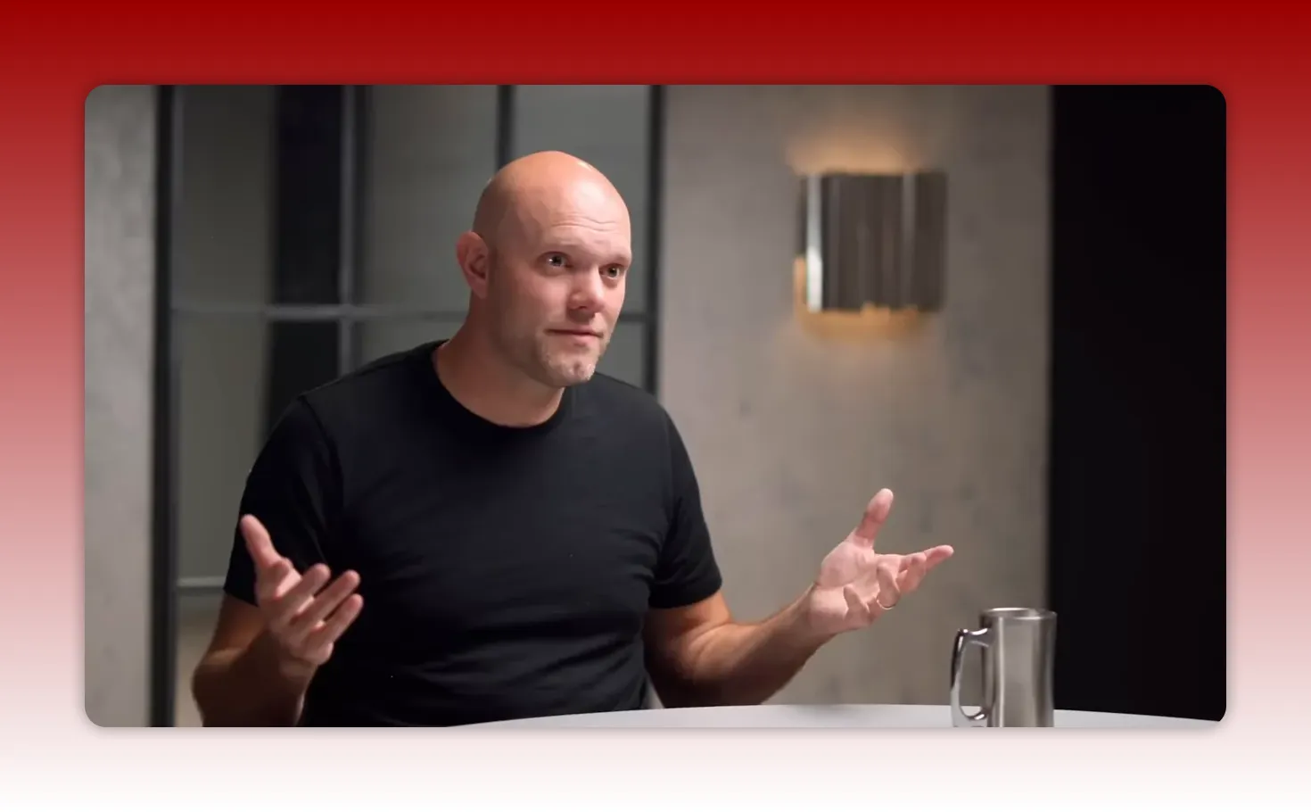Presenter in a black t-shirt with open-palmed gestures at a table, illustrating sequencing and seasons