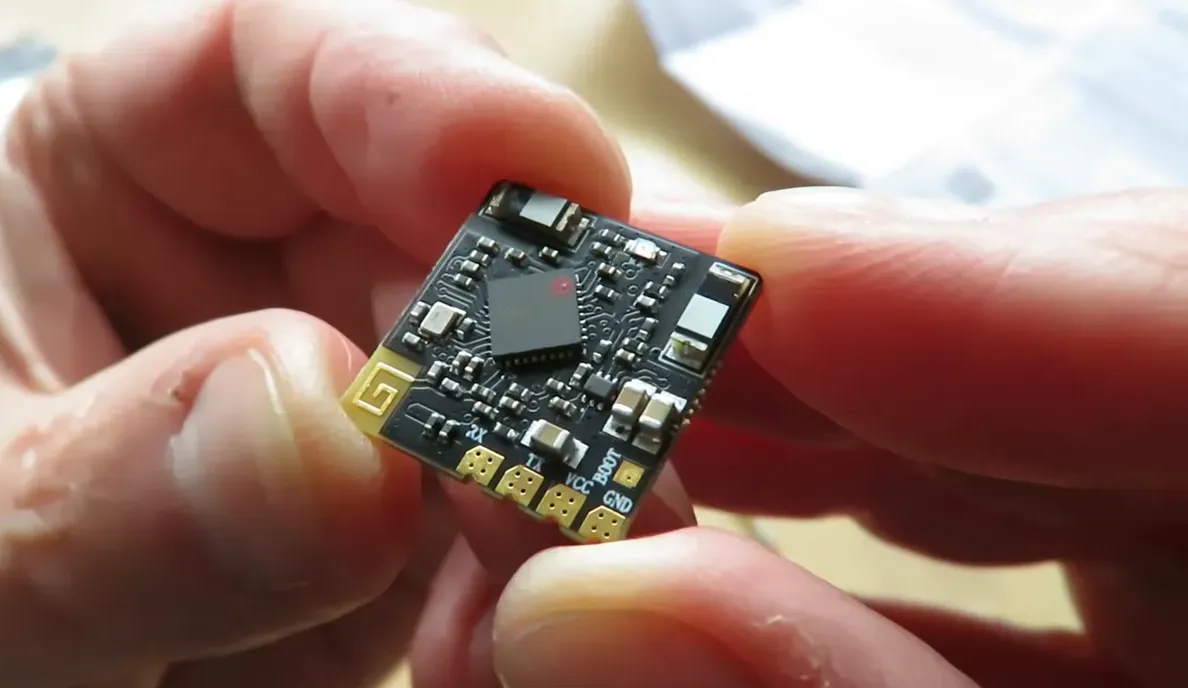 Front-facing close-up of FlySky PR01 receiver showing labeled pads VCC BOOT GND and antenna pad