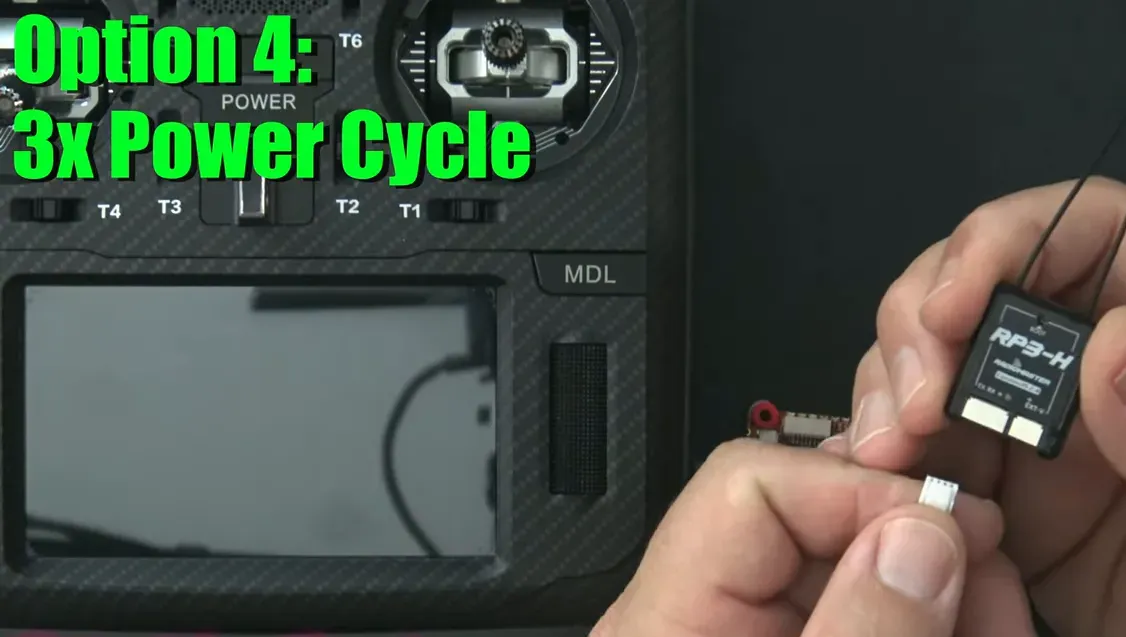 Hands holding an ExpressLRS receiver and a small unplugged power connector, text overlay 'Option 4: 3x Power Cycle'.