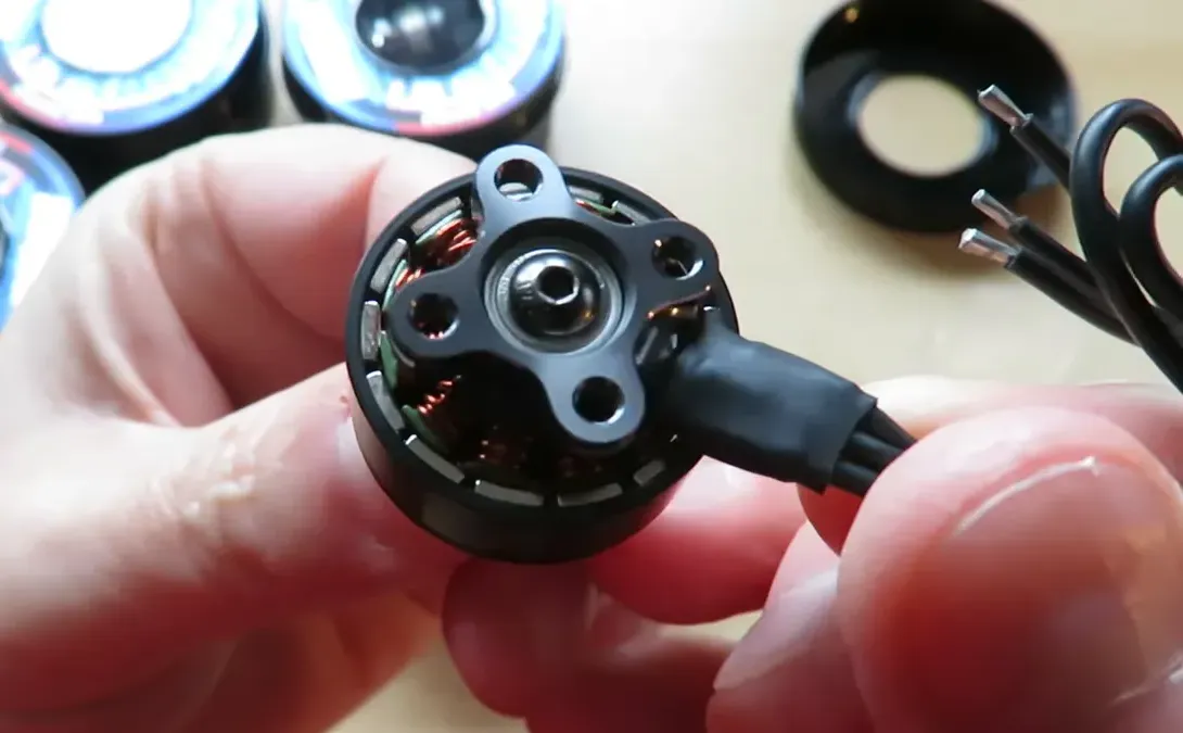 Sharp close-up of F60 Pro V motor interior showing copper windings, bearing and three motor wires with soldered ends