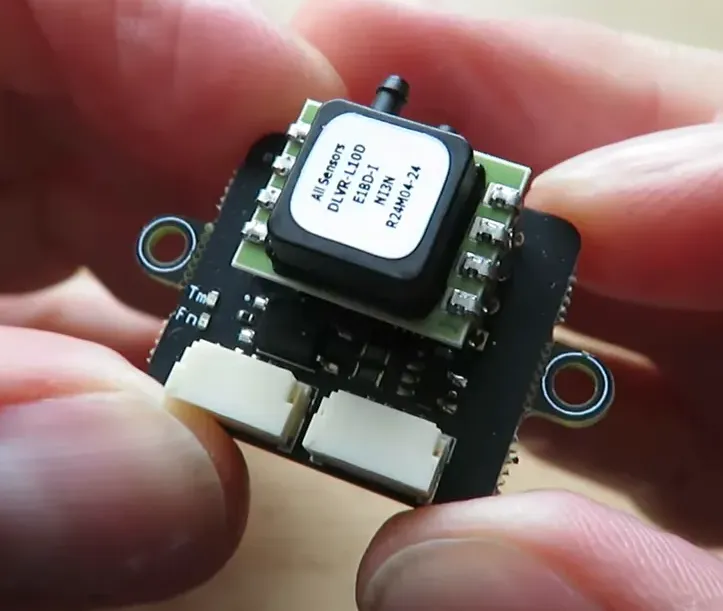 Sharp close-up of TBS DroneCAN PWM board with JST connectors and mounting holes