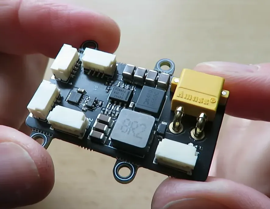 Clear close-up of TBS DroneCAN splitter board with multiple JST GH connectors and an XT30 power plug