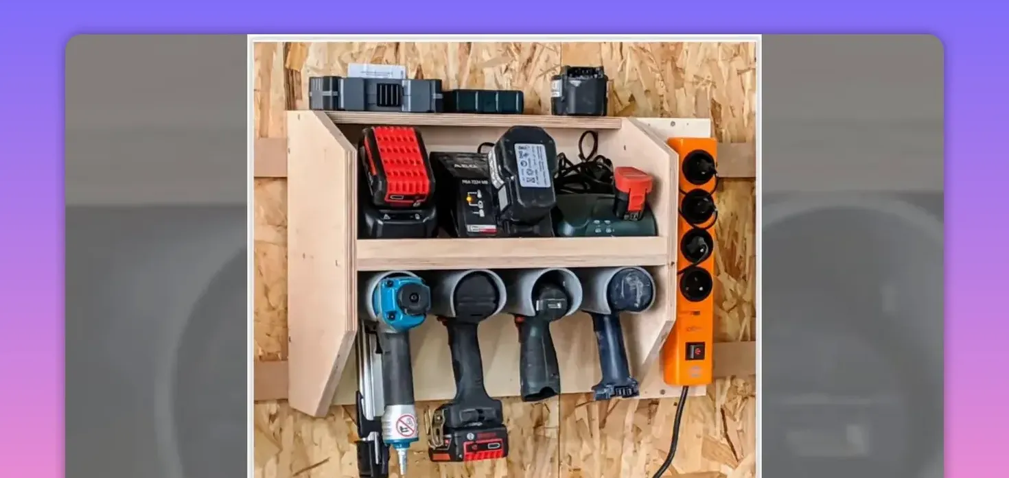 Wall-mounted wooden holder storing cordless drills, batteries and a power strip on OSB wall