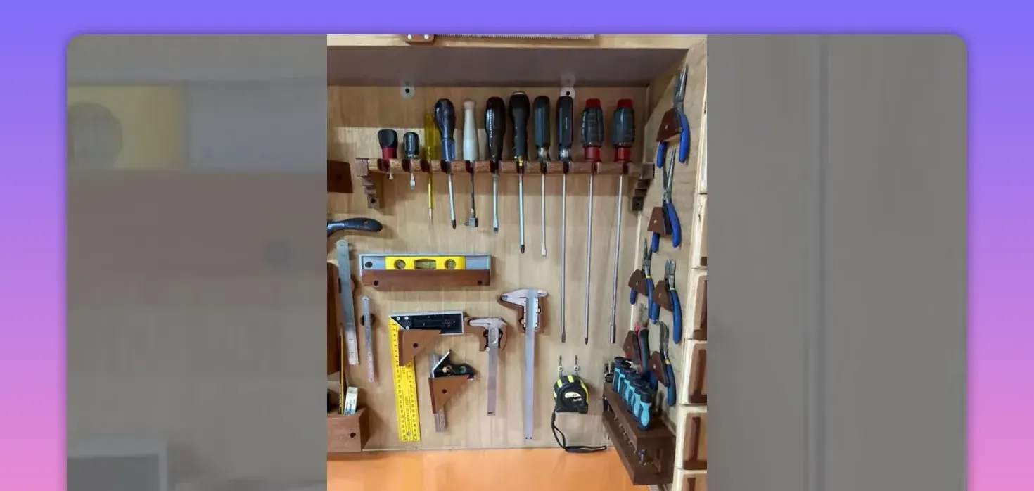 wooden tool organizer with screwdrivers, pliers, squares and small compartments arranged neatly