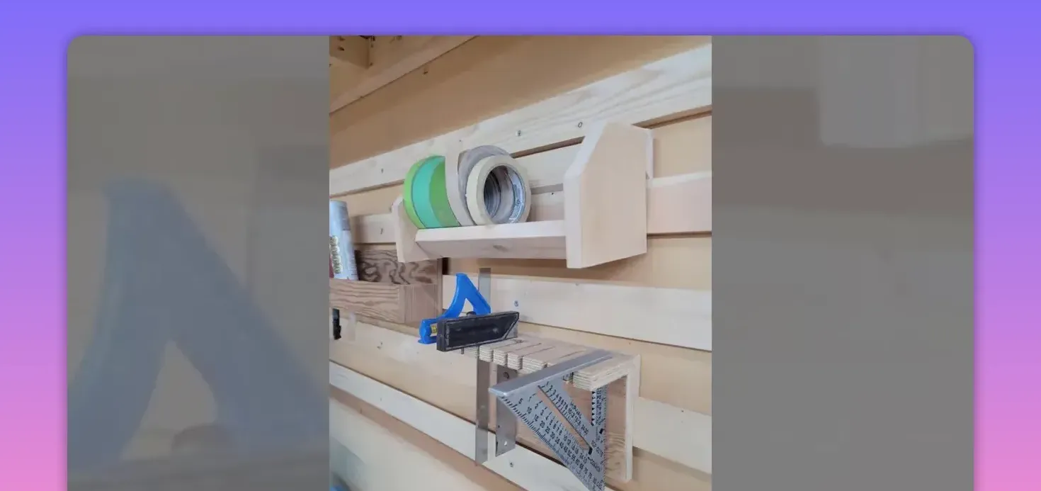 slatwall-mounted wooden shelves and holders storing tape rolls, a try square and other small tools