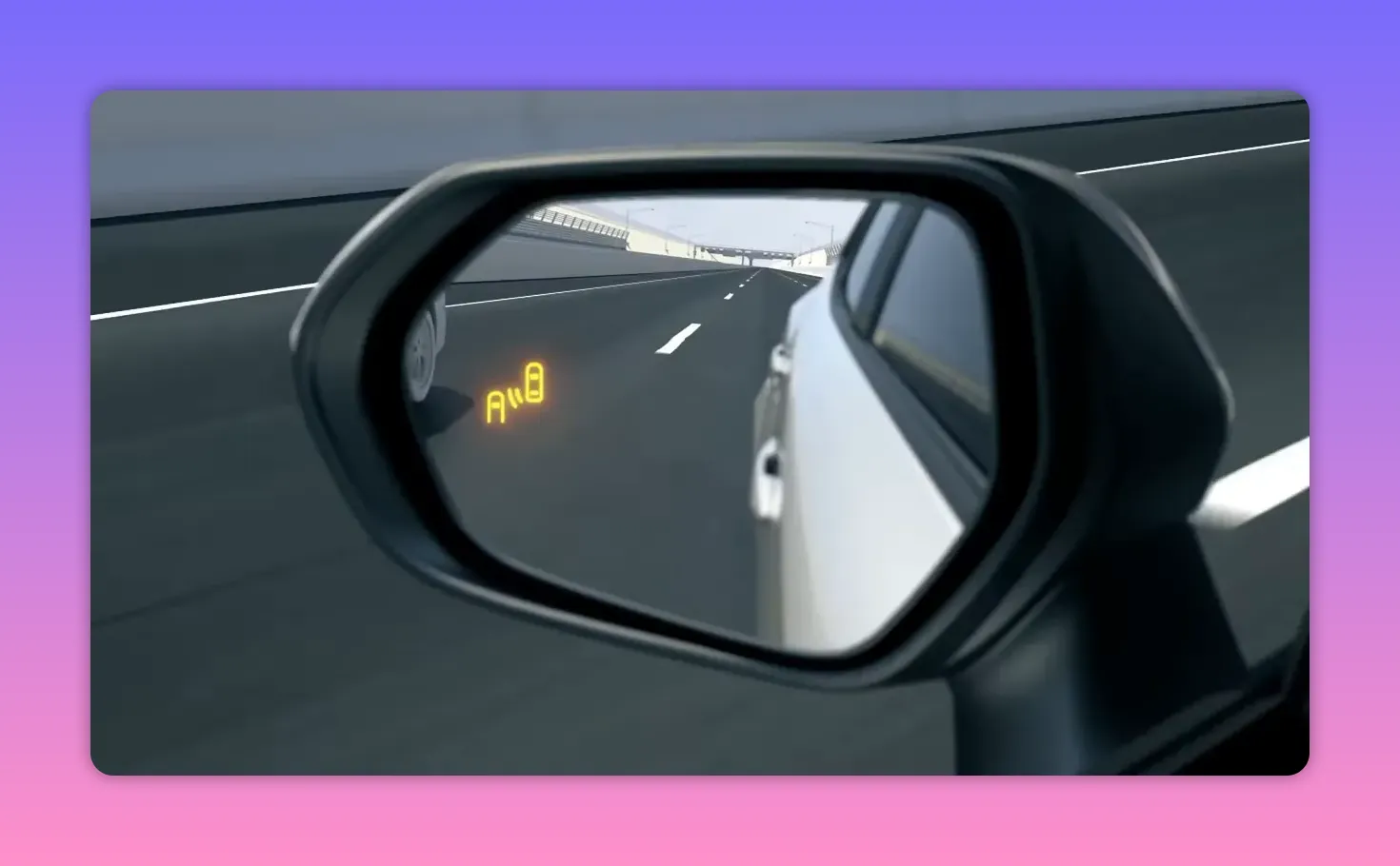 Close-up of side mirror with amber blind spot monitoring icon illuminated