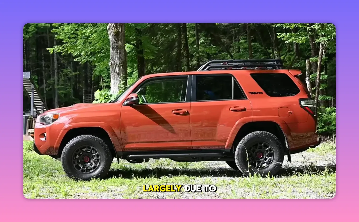 Side profile of orange 2025 Toyota 4Runner TRD parked in a wooded area with roof rack