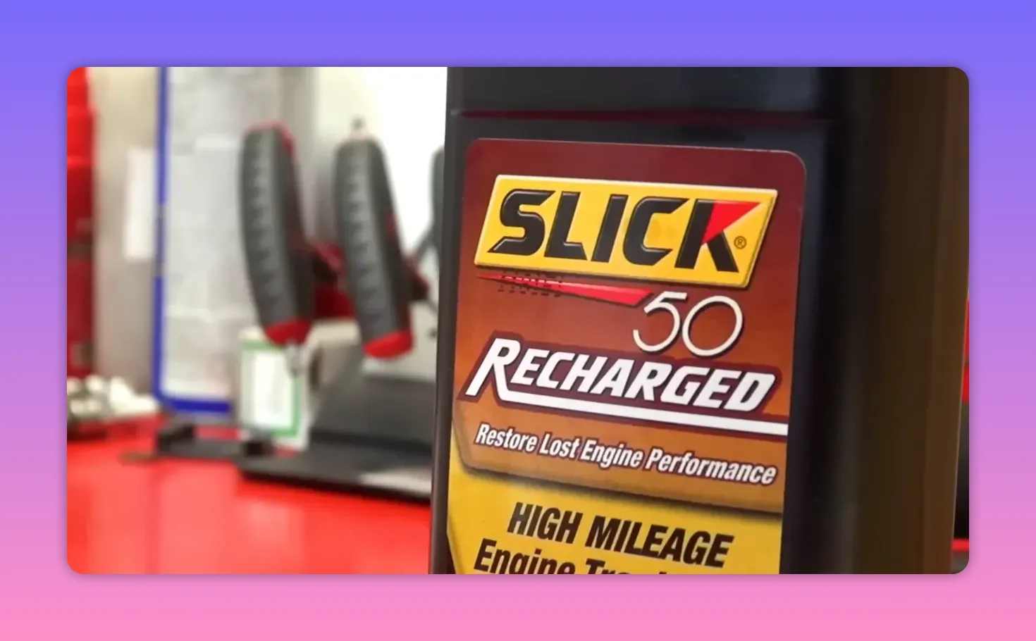 Close-up of a Slick 50 'Recharged' high mileage engine treatment bottle with the Slick logo in focus