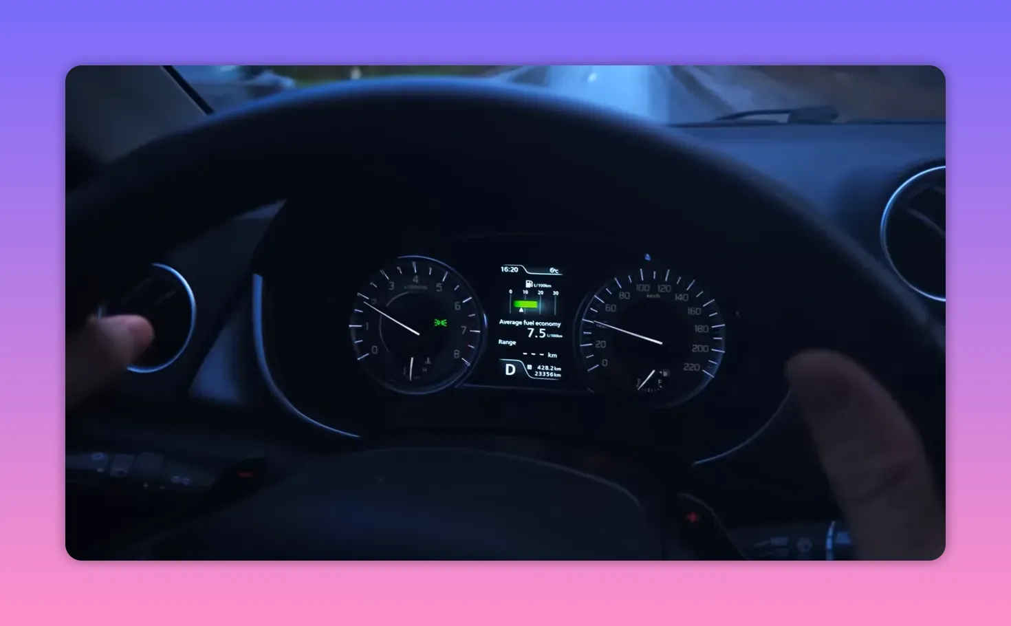 Car instrument cluster showing tachometer, speedometer and a central multi‑information display