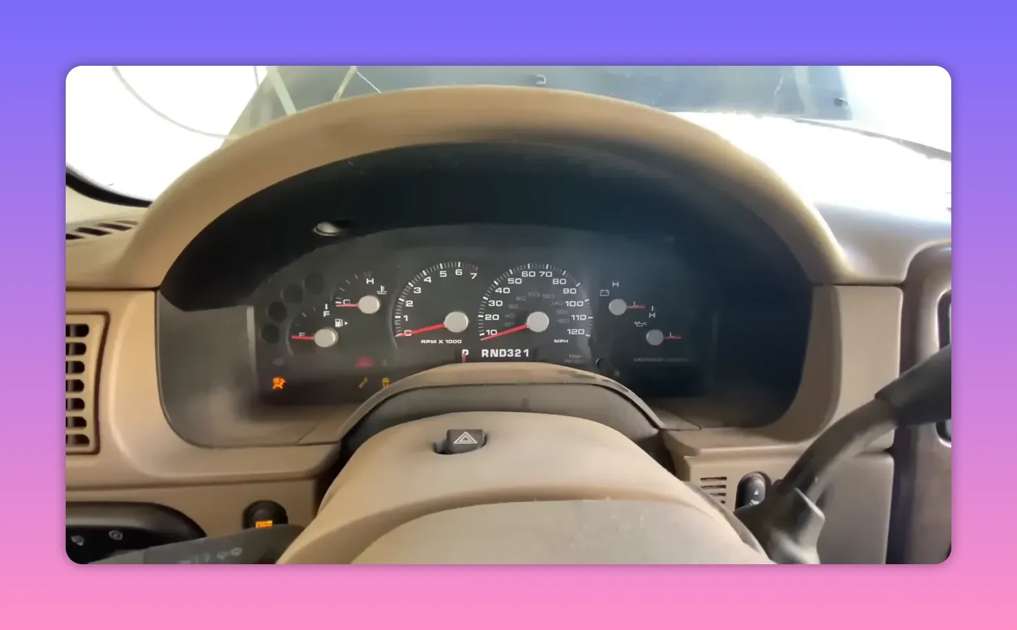 Car instrument cluster showing tachometer, speedometer and warning lights