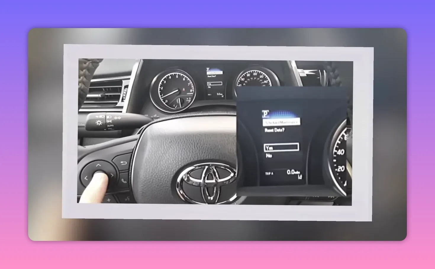 Toyota multi‑information display showing a 'Reset Data? Yes / No' prompt while a finger presses the steering wheel control.
