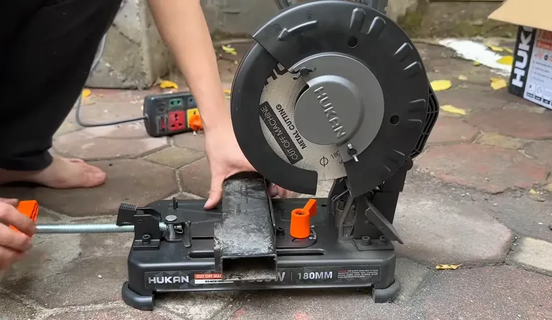 Ống vuông được đặt vào kẹp máy cắt Hucan MCS1800, lưỡi sẵn sàng cắt