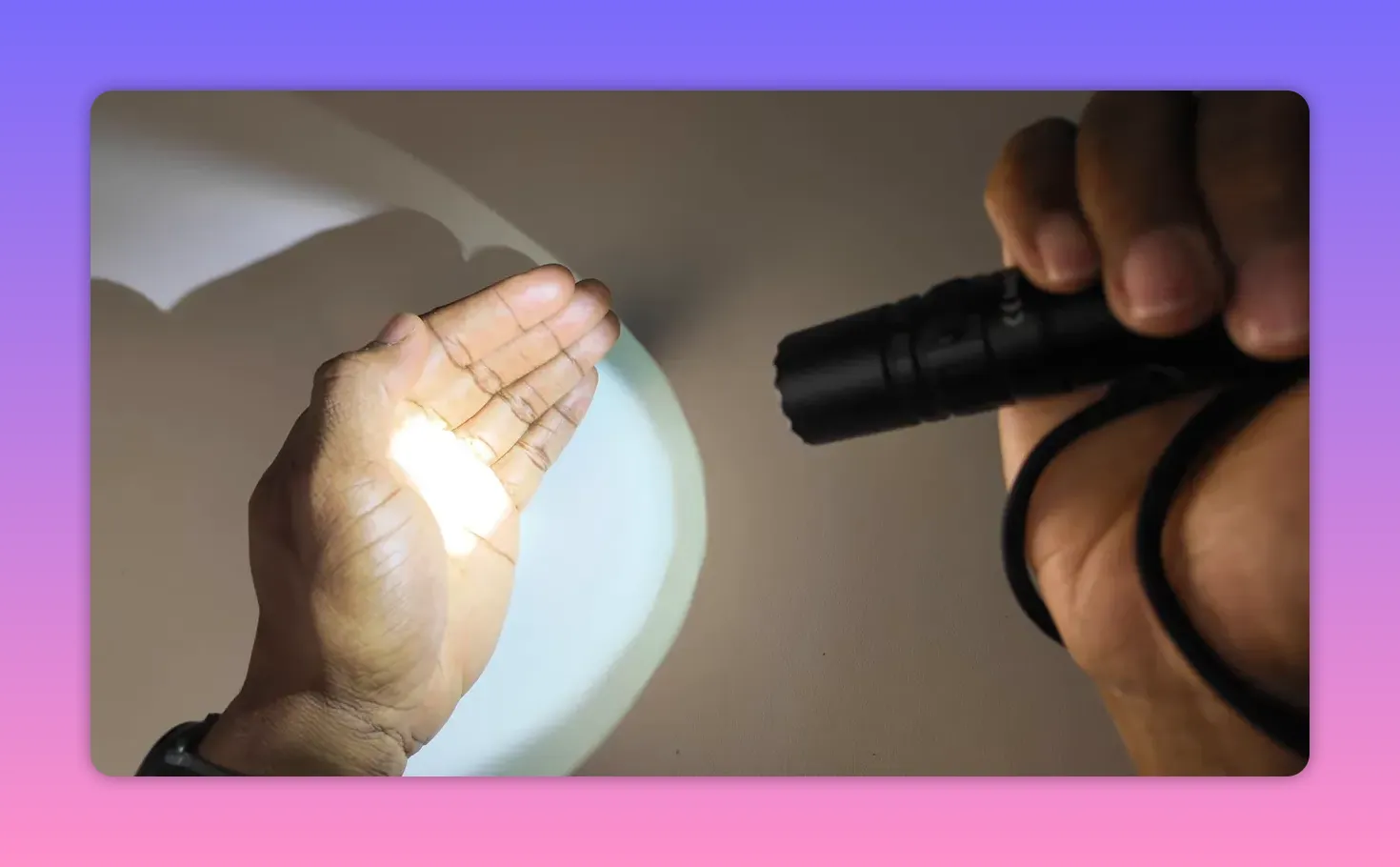 Close-up of flashlight beam on palm showing concentrated hotspot and spill