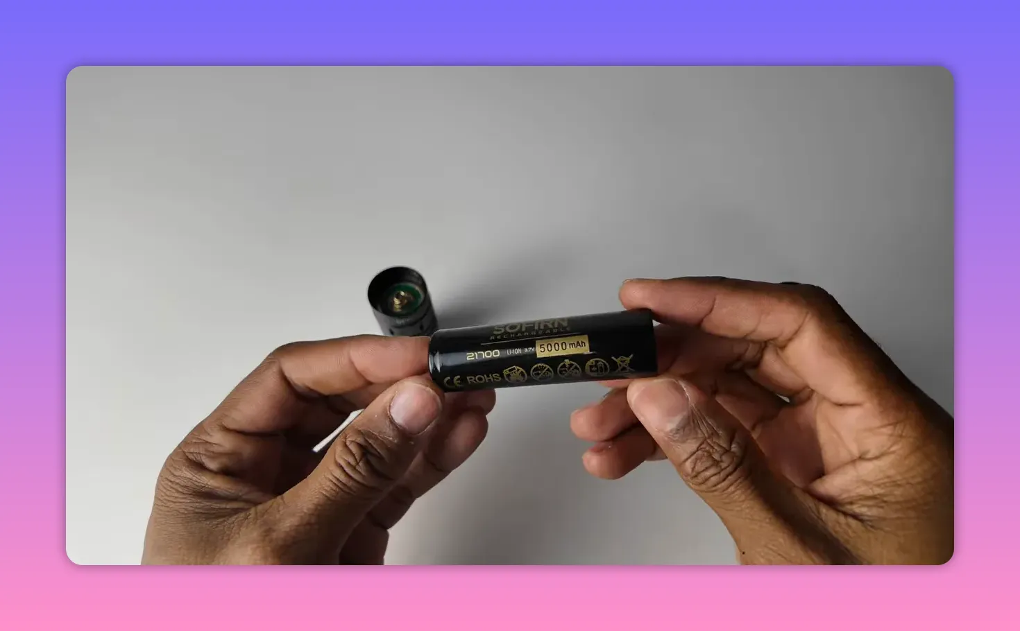 Sofirn SK30 21700 5000mAh battery held in hands with flashlight head in background