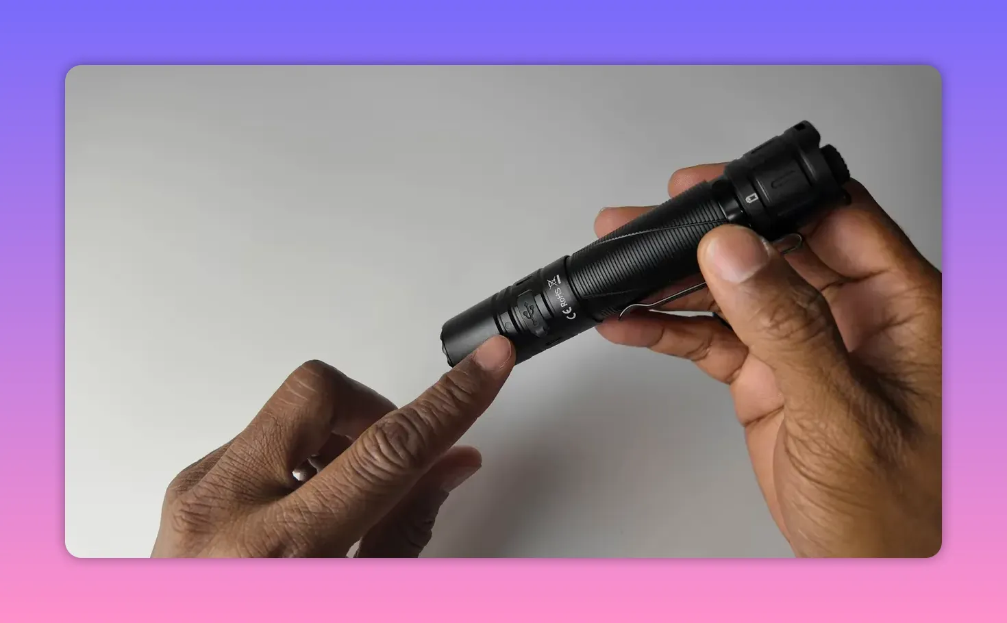 Close-up of Sofirn SK30 showing USB-C charging port and indicator LED with a finger pointing