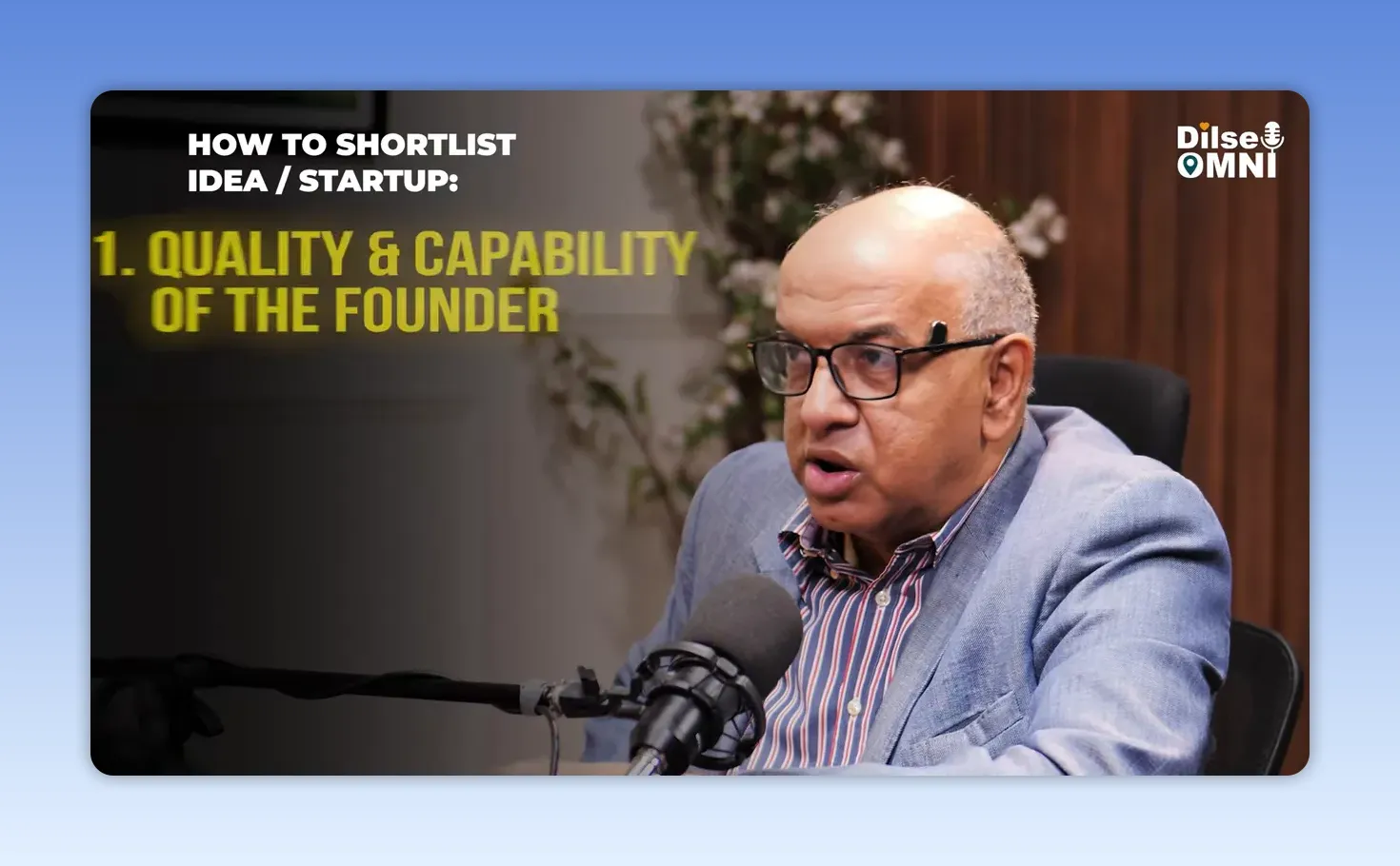 Speaker at podcast table with on-screen text quality and capability of the founder