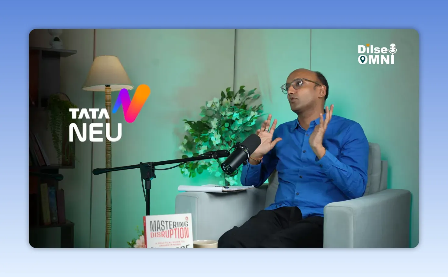 Saurabh Agrawal speaking in a studio with Tata Neu logo graphic on screen