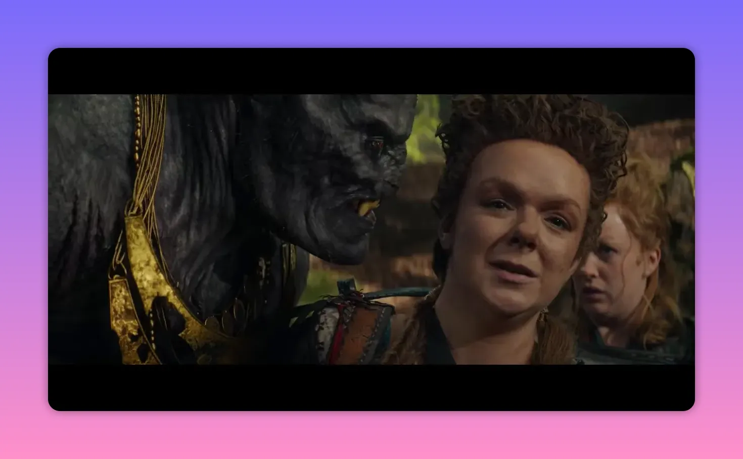 A gray creature leaning toward a companion while another character watches with concern behind them in a wooded clearing