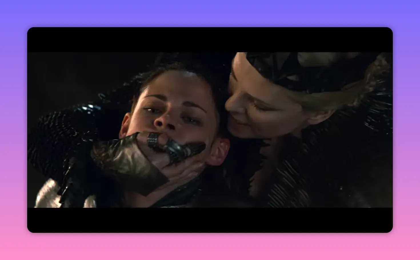 The queen gripping the heroine's face and leaning in, an intimate threatening moment