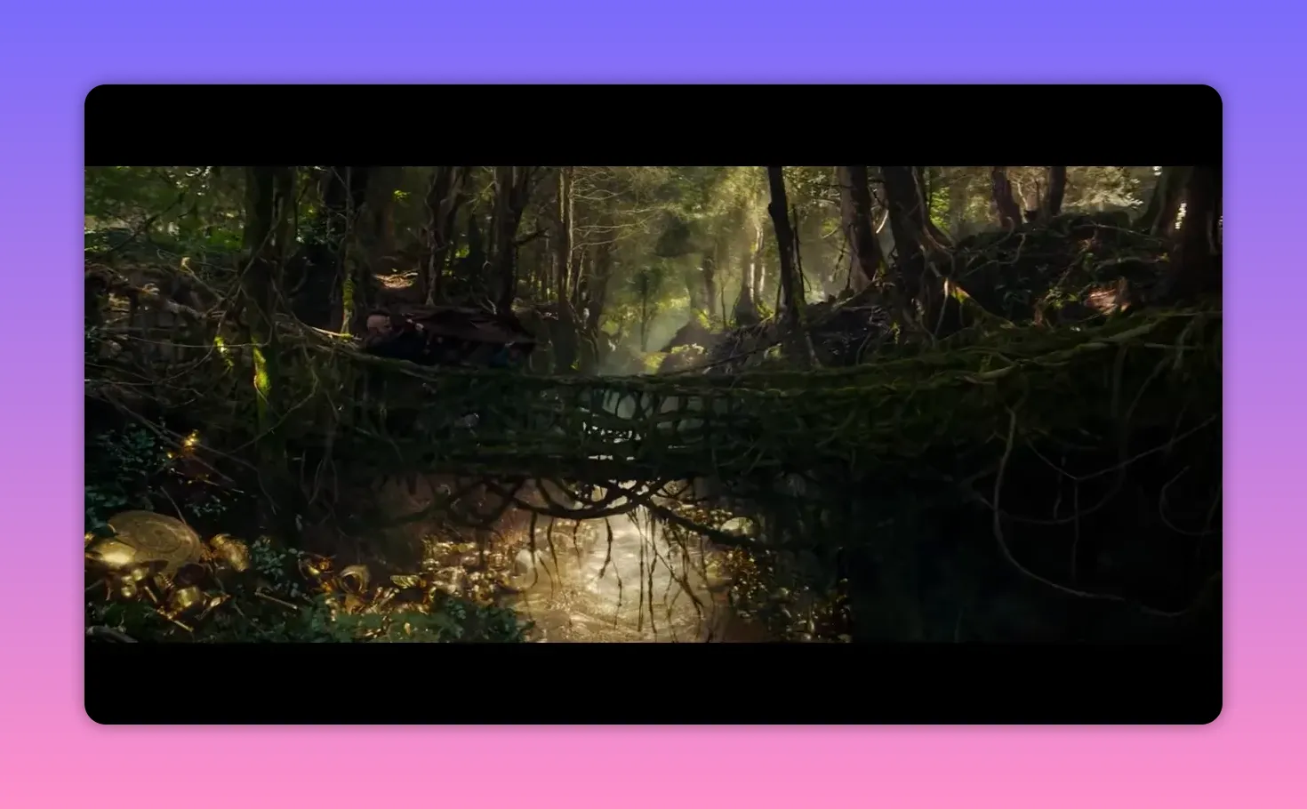 Moss-covered rope bridge spanning a ravine with a sunlit stream and gold-strewn banks below in a dense forest