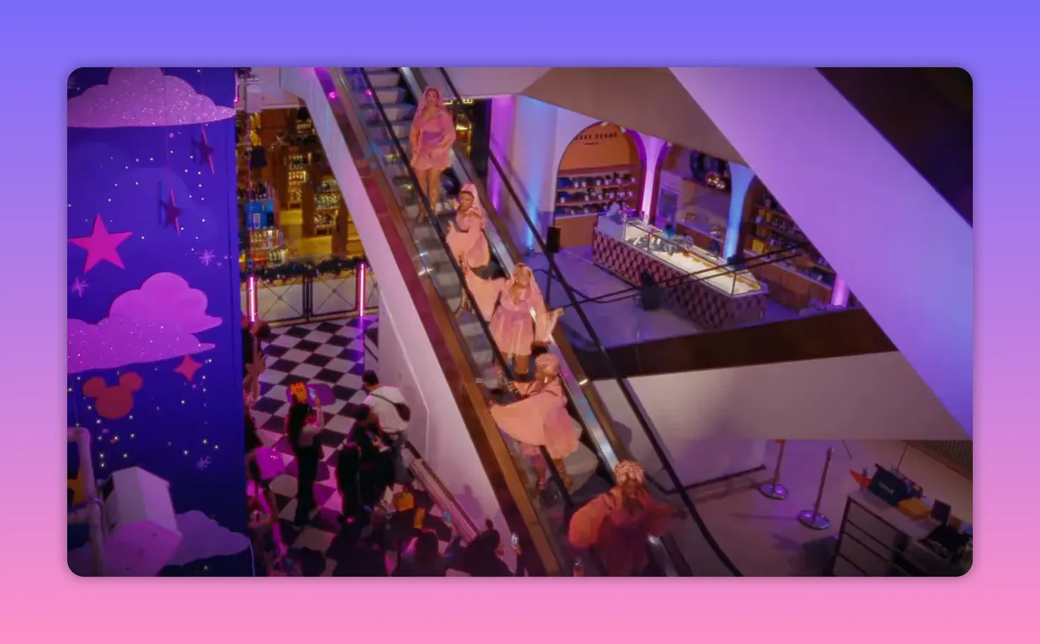 Diagonal wide shot of performers descending an escalator in Selfridges showing costumes, crowd and store interior