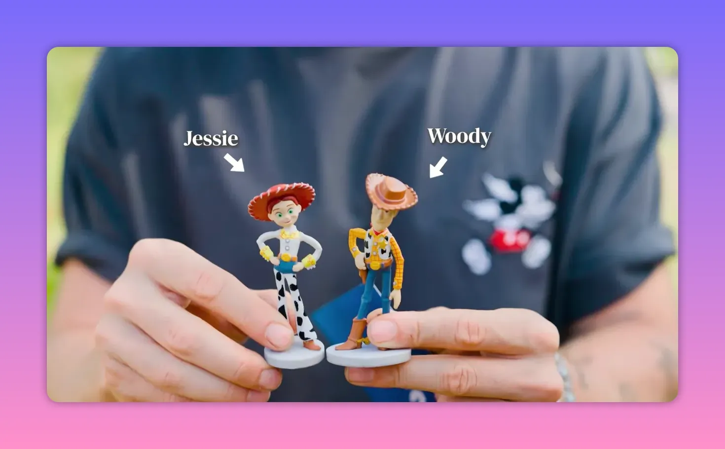 Hands holding small Woody and Jessie Disney character figurines for tactile identification