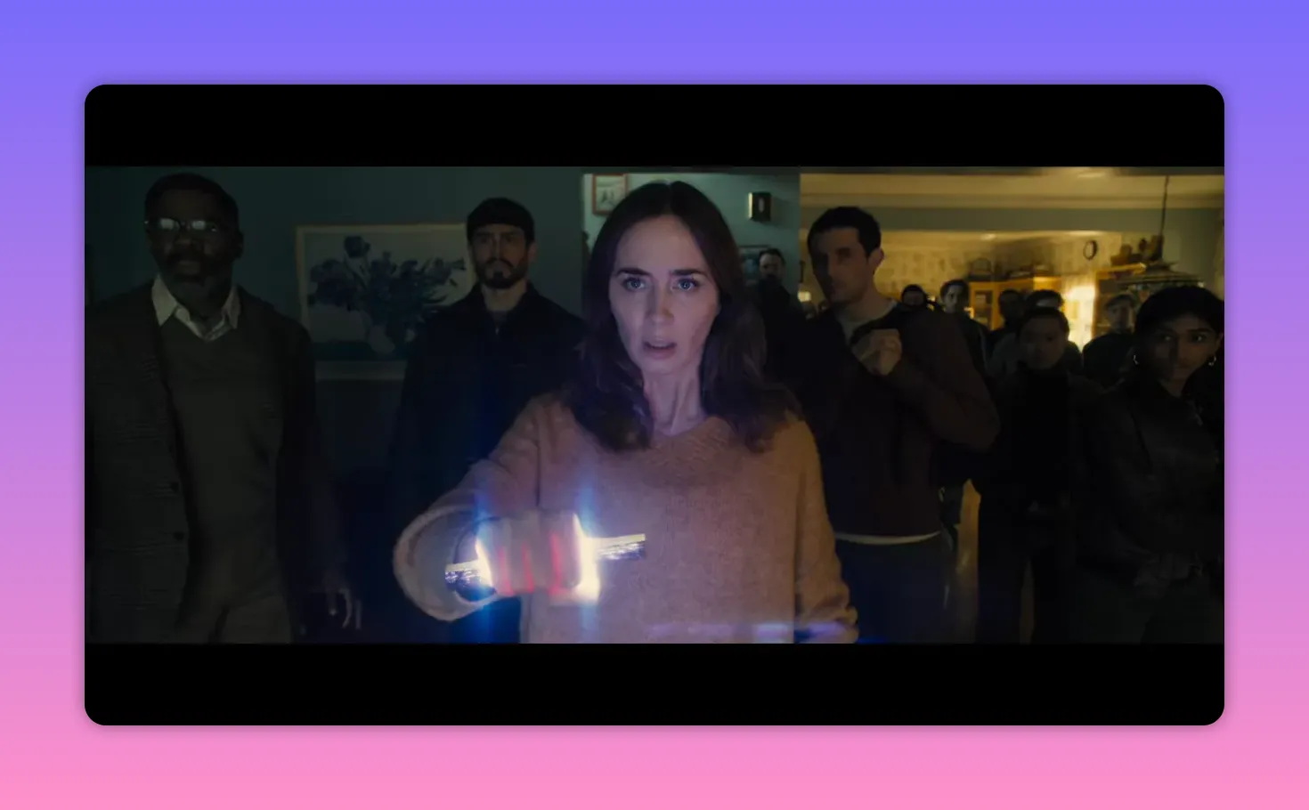 Person holding a glowing artifact forward while a group of onlookers watch closely