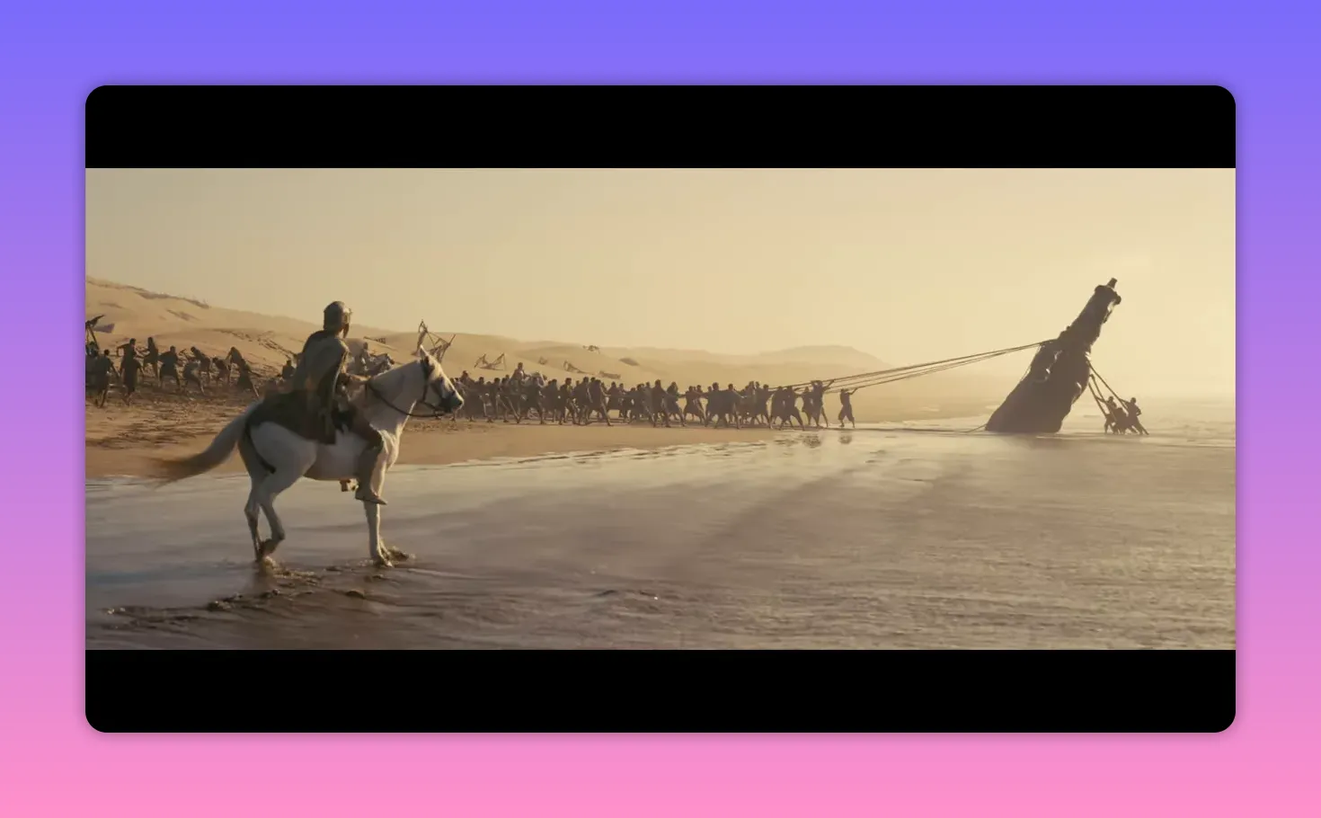 A commander on a white horse observes a long line of men pulling a grounded ship along a sunlit beach