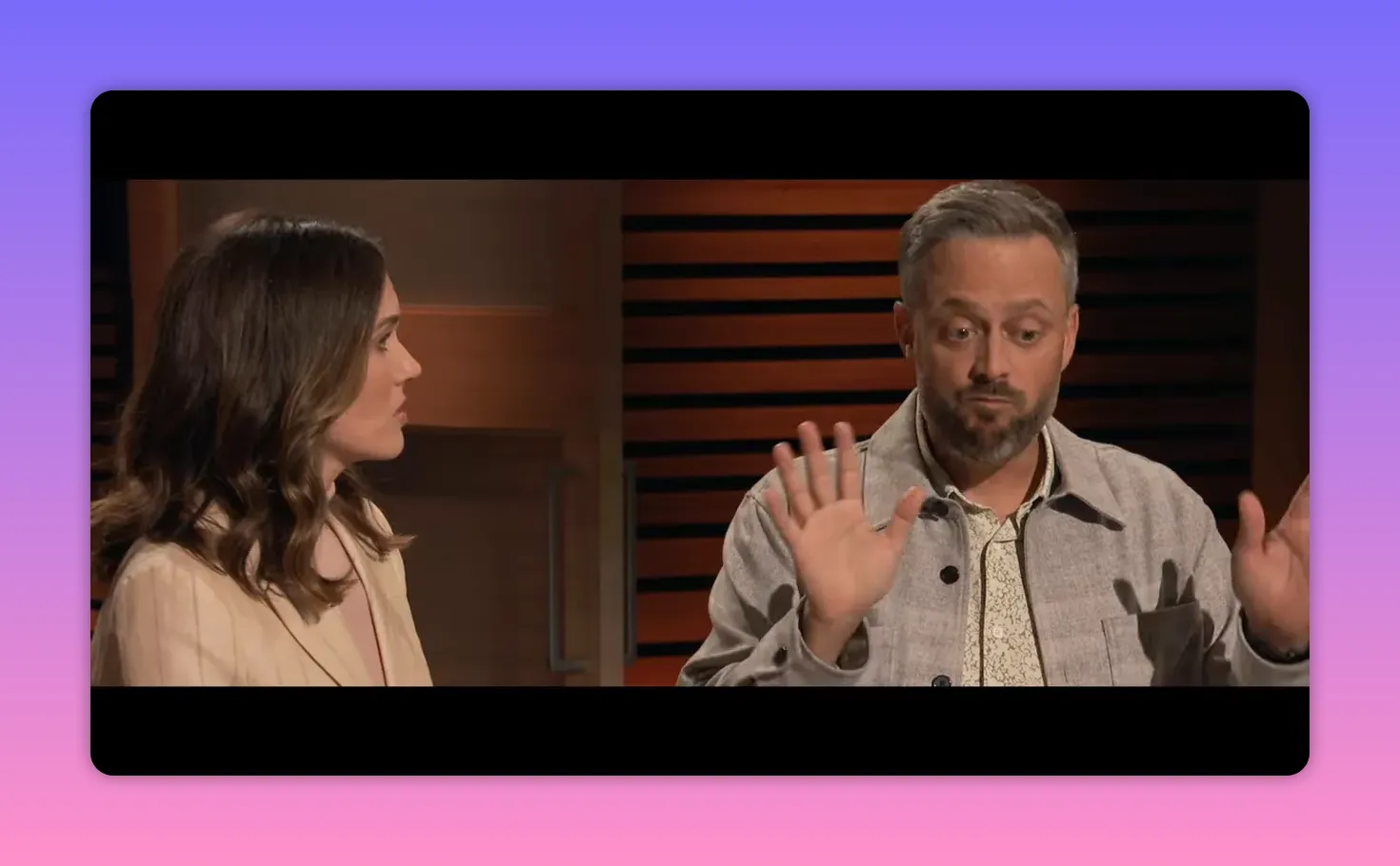 Two characters in conversation with the man raising his hands in a defensive gesture